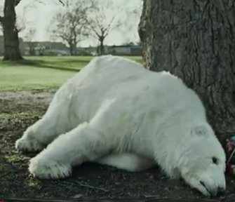 Polar bear Greenpeace ad slumped on tree