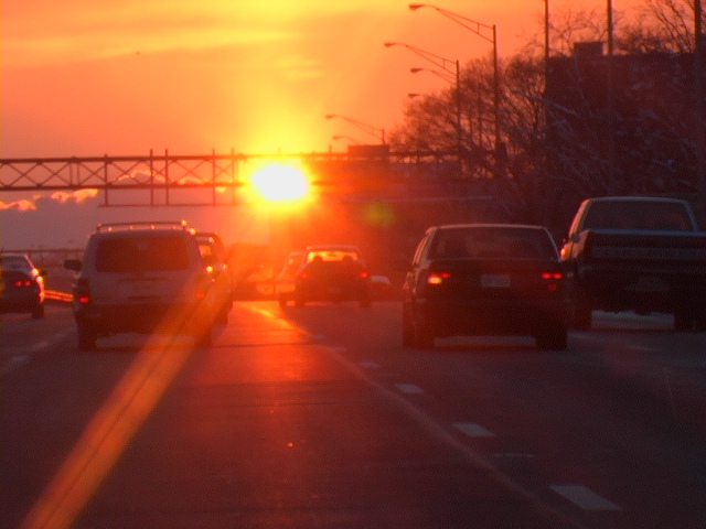 cars driving at sunset