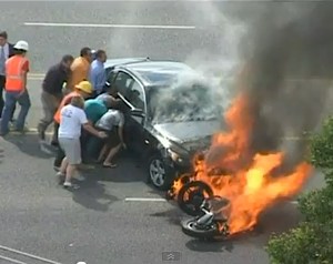 Motorcyclist under burning car - YouTube video