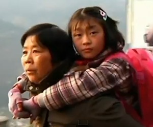 Chinese grandmother carries girl to school every day in China