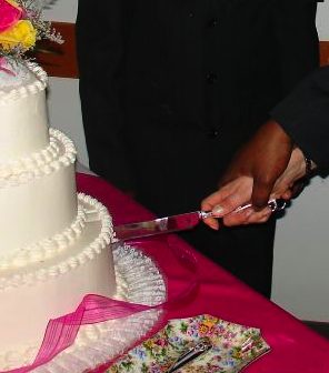 interracial couple cuts wedding cake by kakisky, via Morguefile