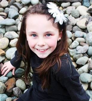 Photo of Rachel Beckwith with a black dress and flower in her hair