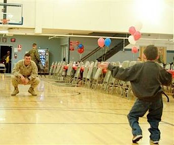 boy walks into soldiers arms