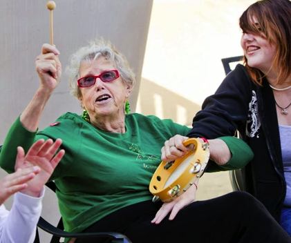elderly woman plays tamborine - EngAGE photo