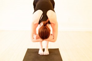 yoga-back-fists-forward-fold-Gaiaim