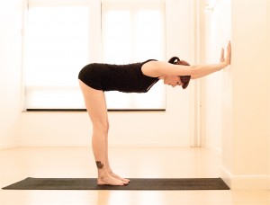 Wall Plank yoga pose via Gaiam.com