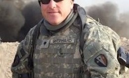 Soldier in Iraq poses family photo