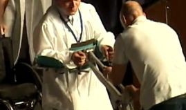 disabled student walks to graduate