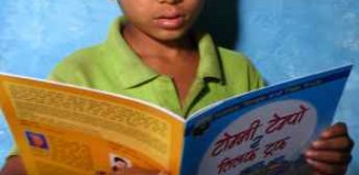 boy reads in Nepal - Room to Read photo