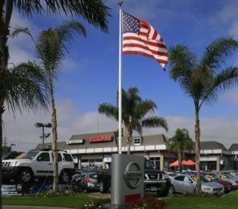 Nissan lot with flag palm trees