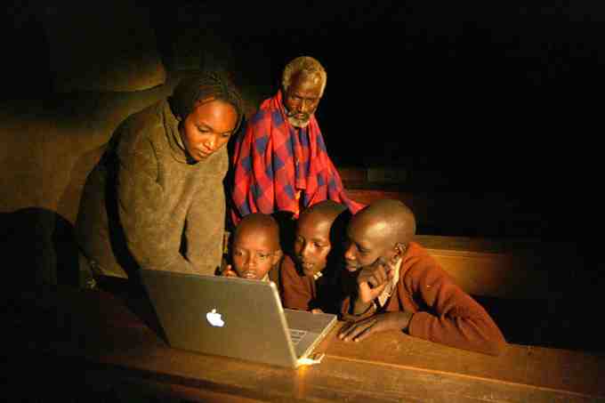 Masai students work at night, after herding during the day