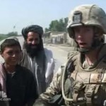 US soldier talks to Afghan villagers