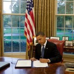 obama-signs-at-desk.jpg