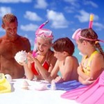 family-at-beach-flippers-sun