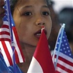 Indonesian child holds US flags -USAID photo