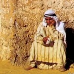 Arab man leans against wall