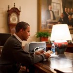 Obama reads letters at desk WH photo