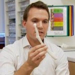 Doctor holds plastic bone - BBC video snapshot