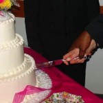 interracial couple cuts wedding cake by kakisky, via Morguefile