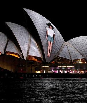 Sydney Opera House with a projected woman on front