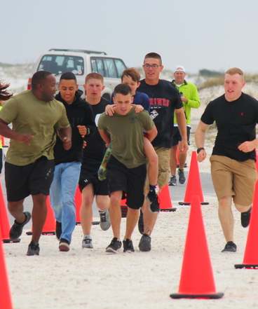racing marines carry boy w Prosthetic
