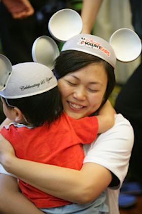 Mother hugs daughter at Mickey Mouse event