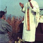 Catholic Army Chaplain holds mass in field