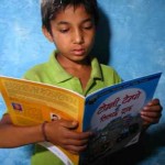 boy reads in Nepal - Room to Read photo