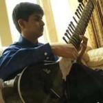 sitar playing boy aces SAT-KGOvid