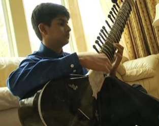 sitar playing boy aces SAT-KGOvid