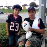 football autograph given to wheelchair-bound boy, family photo