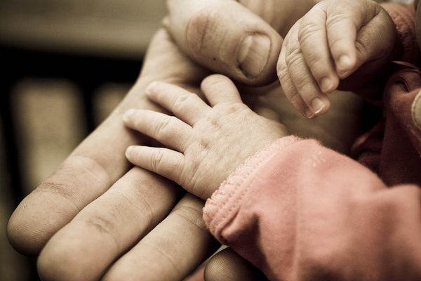 hands holding baby elder-Flickr-aarongilson-CC
