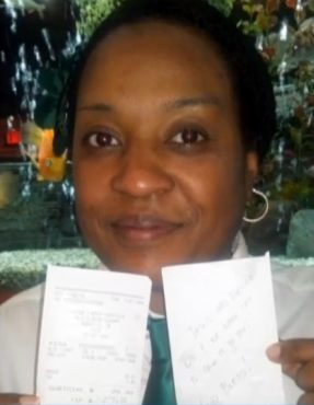 waitress holds tip receipt for thousand dollars