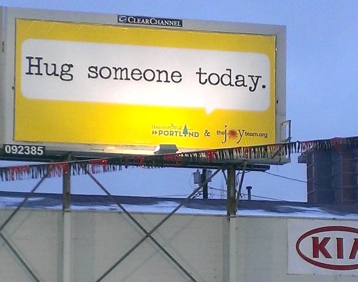 Hug someone today billboard The JoyTeam