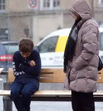 boy shivering on bench lady stands-YouTube