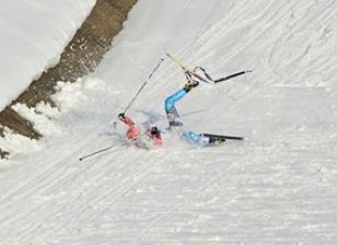 skiier falls in Olympic x-Country event