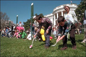 Kids race to push Easter eggs with spoons on White House lawn.