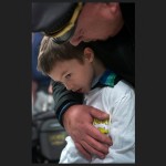 Brimfield Township Police Chief David Oliver comforts 6yo Kashe Heffelfinger