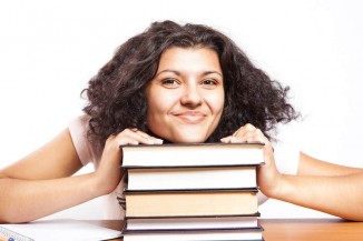 college student smiling with books-cc-CollegeDegrees360