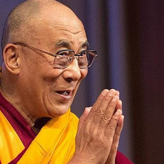 Dalai Lama praying hands cc Christopher.Michel