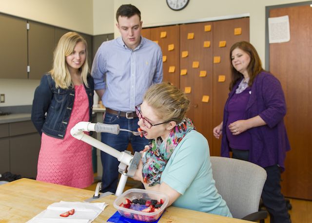 Notre Dame students Emily Cunningham, Michael Boyle and occupational therapist Heather Beaver work with patient Katelyn Toth