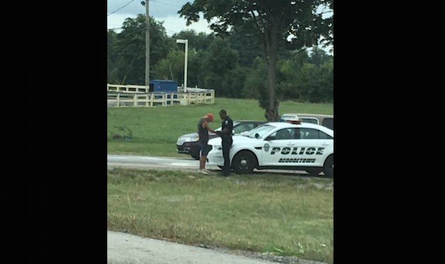 cop prays with man at car-Rita Baker-FB