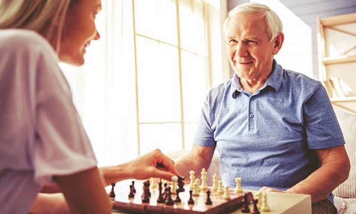 Senior Playing Chess With College Student-Join Papa Facebook Page
