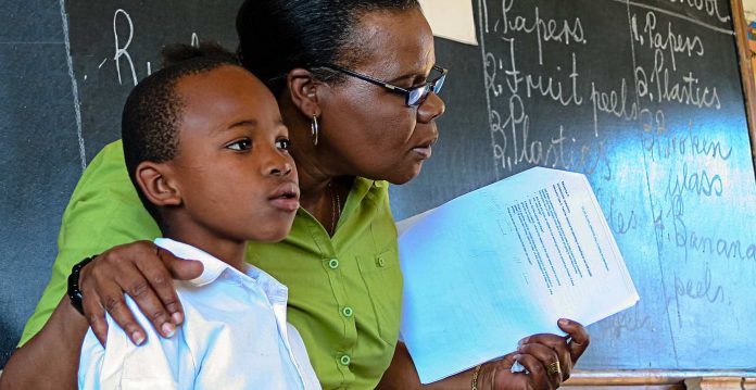 black boy student with teacher-school-classroom-cc-community eye health-deltafoundationDOTnet