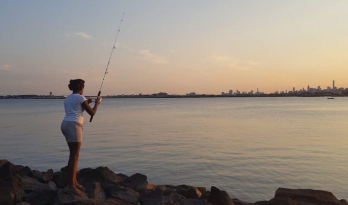 Woman Fishing at Sunset on New York City-Lydia Clark-Sumpter