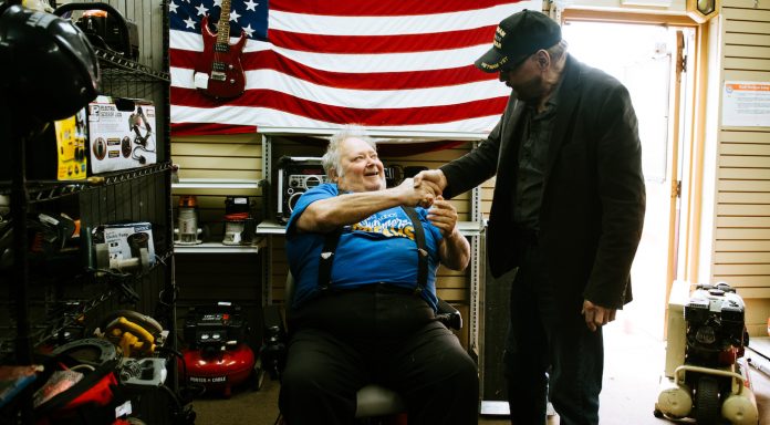 Phillip shakes hands with motorized wheelchair recipient-GoFundMe Heroes