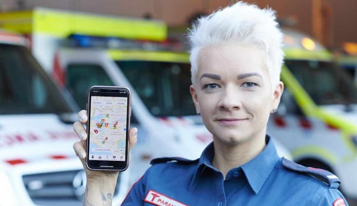 Woman Holding GoodSam App Phone-Ambulance Victoria Website