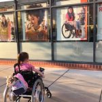 Hearts Are Melting Over Little Girl Admiring a Beauty Ad Depicting Woman in a Wheelchair