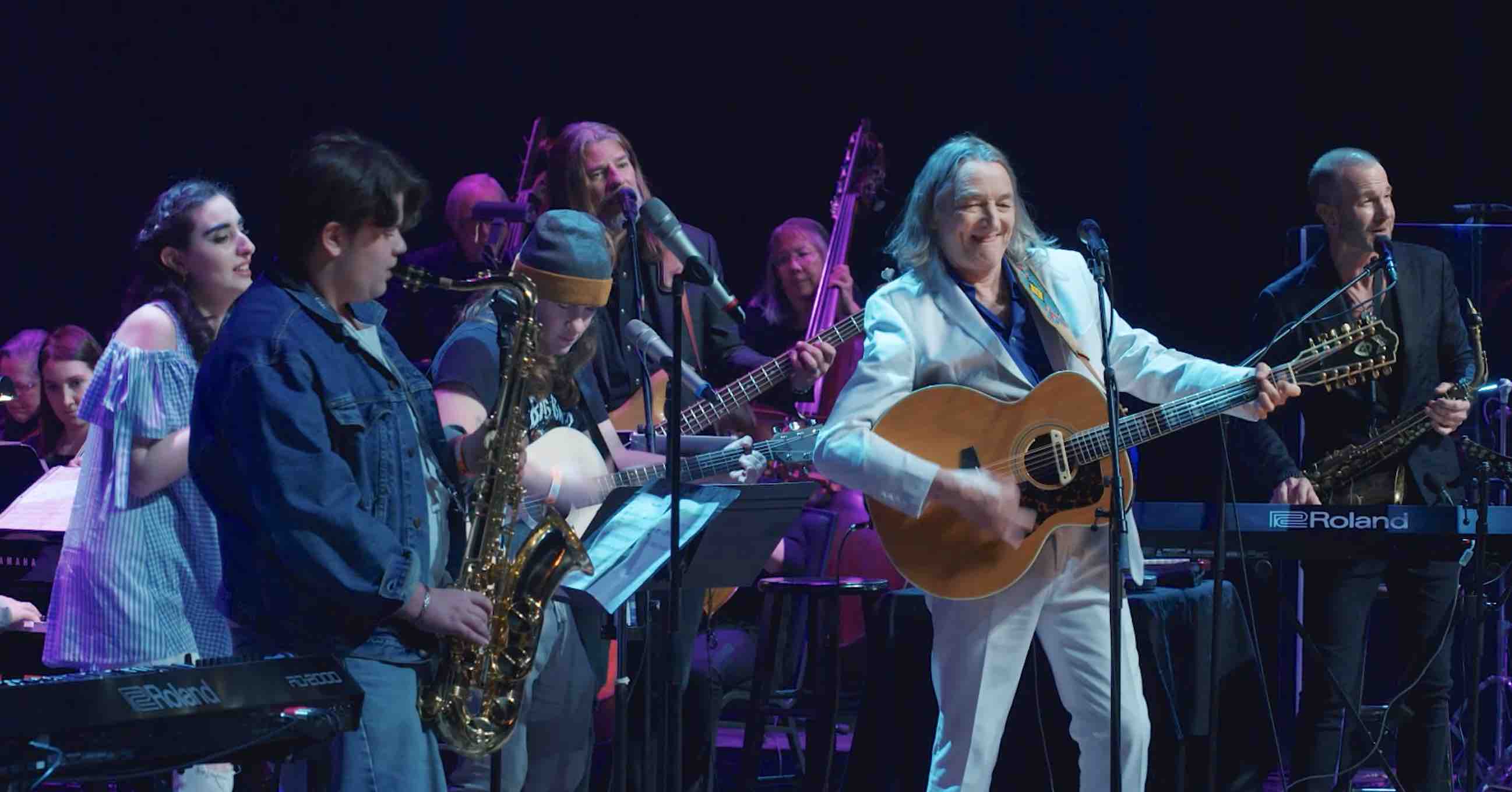 Supertramp Singer 'Gives a Little Bit' Inviting Teens With Autism on Stage  to Perform with 39 Piece Orchestra - Watch