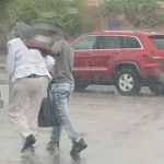 Awestruck Police Officer Snaps Photo of Teen Using His Jacket to Shield an Older Woman From the Rain